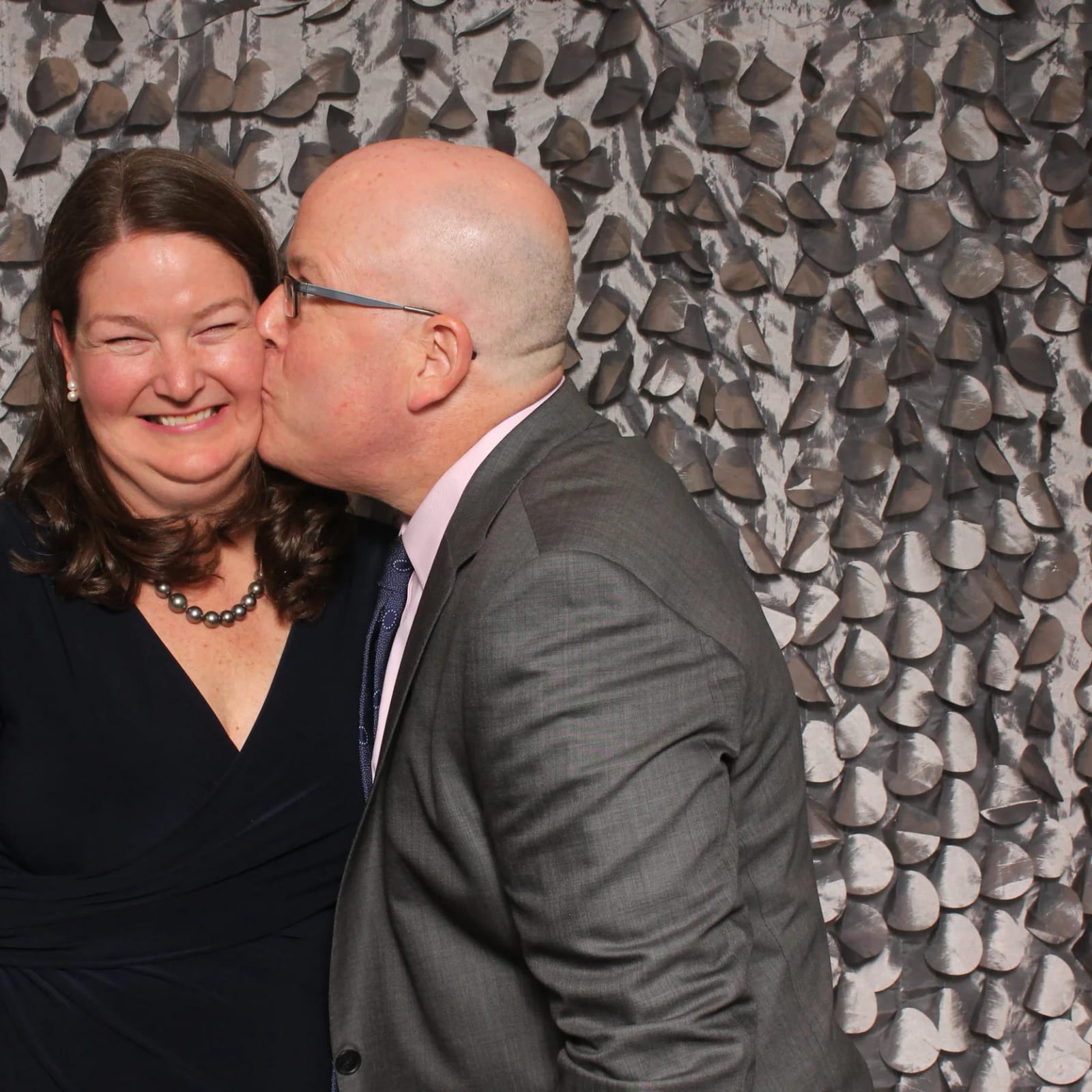 A pair of guests sharing a candid moment in the photo booth